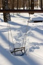 Children`s playground with swings covered with snow Royalty Free Stock Photo