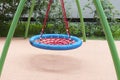 Children`s playground with swings. Rope circle blue on a swing. Children`s entertainment