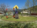 Children`s playground with swings and slide Royalty Free Stock Photo
