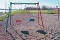 Children`s playground on the waterfront in the city two lonely swing