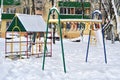 Children`s playground in winter