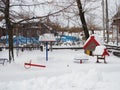 Children`s playground in the winter snow-covered city park Royalty Free Stock Photo