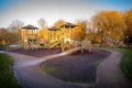 Children's playground wooden play structure fort with ramp, ladder, bridge and climbing ropes. Royalty Free Stock Photo