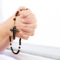 children's prayer. Christian prayer. Wooden rosary beads with a cross Royalty Free Stock Photo