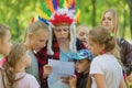 Children`s relay race. Children get a task from the hero.