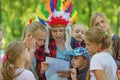 Children`s relay race. Children get a task from the hero.