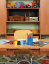 Children`s room with drawing facilities on the table. Pencils, markers, paints and drawing sheets are laid out on the children`s