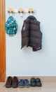 In the children`s room on the hanger hangs a jacket and there are d shoes