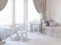 Children`s room in a luxurious white color, with a bed, a wardrobe and a children`s game table