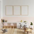 Children`s room with a picture frame on the walls in white and cream colors. With books placed on the table and toys on the floor Royalty Free Stock Photo