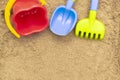 Children`s sand toys: shovel, rake and bucket. Sandbox outdoor. Royalty Free Stock Photo
