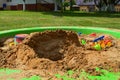 Children`s sandbox on the playground for games with toys for children by truck, car, excavator, sand dressers with a spatula Royalty Free Stock Photo