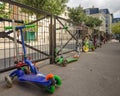 Children's scooters are locked to school yard fence in Paris