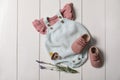 Children`s shoes, clothes, pacifier and lavender on white wooden table Royalty Free Stock Photo