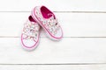 Children`s shoes for girls in florets on a wooden background. Fl Royalty Free Stock Photo