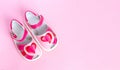 Children`s shoes with a red heart. Isolated on pink background. Copy space Royalty Free Stock Photo