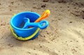 Children`s shovel and rake and bucket lie on the sand Royalty Free Stock Photo