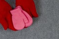 Baby pink mittens. The concept of family care and joy