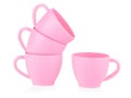 Children`s small pink mugs stand on top of each other on a white background. Toy set made of plastic. The concept of a tea party. Royalty Free Stock Photo