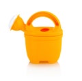 Children`s small plastic watering can isolated on the white background with shadow reflection. Watering-can toy. Royalty Free Stock Photo