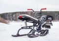 A children\'s snowmobile is ready for children to ride in the snow Royalty Free Stock Photo