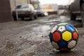 Children`s soccer ball lying on a dirty street