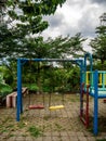 Children`s swing in a deserted playground due to the covid pandemic
