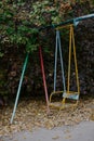 Children's swing for one person. Retro playground. Yard equipment in CIS countries during the Soviet Union. Royalty Free Stock Photo