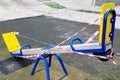 Children`s swing on a playground in a recreation park wrapped with red barrier tape Royalty Free Stock Photo