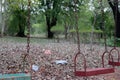 Children`s swings hang empty an idle at a playground on a dull, overcast day. Lost child day Royalty Free Stock Photo