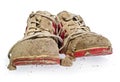 Children`s tiny shoes covered with mud. Dirty leggings for child