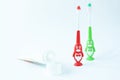 Children& x27;s toothbrushes in a form of red and green penguins on a white background 