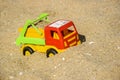 Children`s toy car, colorful plastic lorry on beach sand Royalty Free Stock Photo