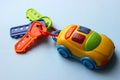 Children`s toy car with keys. Toy keychain from the car. Multi-colored key with keychain.