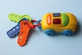 Children`s toy car with keys. Toy keychain from the car. Multi-colored key with keychain.