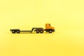 Children's toy, car on a yellow background. Car transporter, evacuator Concept. Isolate. Copy space.