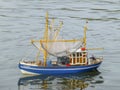 Children`s Toy Of Fishing Boat Is Floating On The Lake. Ship Model
