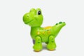 Children`s toy green dragon on a white background plastic