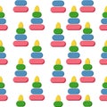 Children`s toy pyramid seamless pattern, a bright game from multi-colored parts on a white background