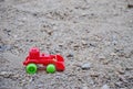 Children`s toy red excavator car on playground, industrail symbols