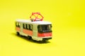 Children's toy red white tram on a yellow background copy space for text. Toys for a toy store, cars for a boy. Royalty Free Stock Photo