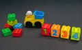 ChildrenÃ¢â¬â¢s toy truck and building blocks of varying colours and numbers one to four Royalty Free Stock Photo