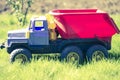 Children`s toy truck colorful car on the green grass Royalty Free Stock Photo