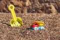 Children`s toy truck with gravel or sand. Yellow scoop on the background. Concept of transportation of goods and Royalty Free Stock Photo