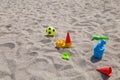 children's toys on the beach sand against turquoise sea