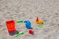 children's toys on the beach sand against turquoise sea