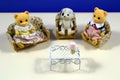 Children\'s toys bears sit in chairs.