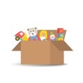 Children`s toys in a cardboard box. There is a teddy bear, a truck, a ball, a clown, cubes and a doll Royalty Free Stock Photo