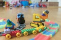 Children's toys on the floor. Close-up. Children's excavator, train and car