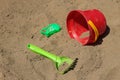 Children`s toys left on the sand, a bucket, a scraper and a mold for sculpting figures